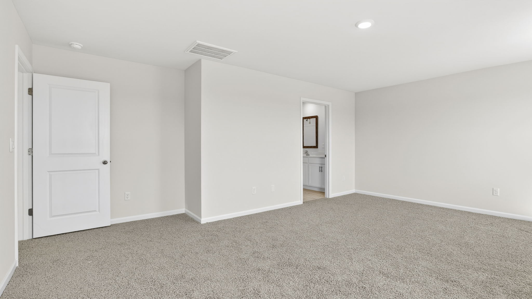Bedroom with carpet and windows.