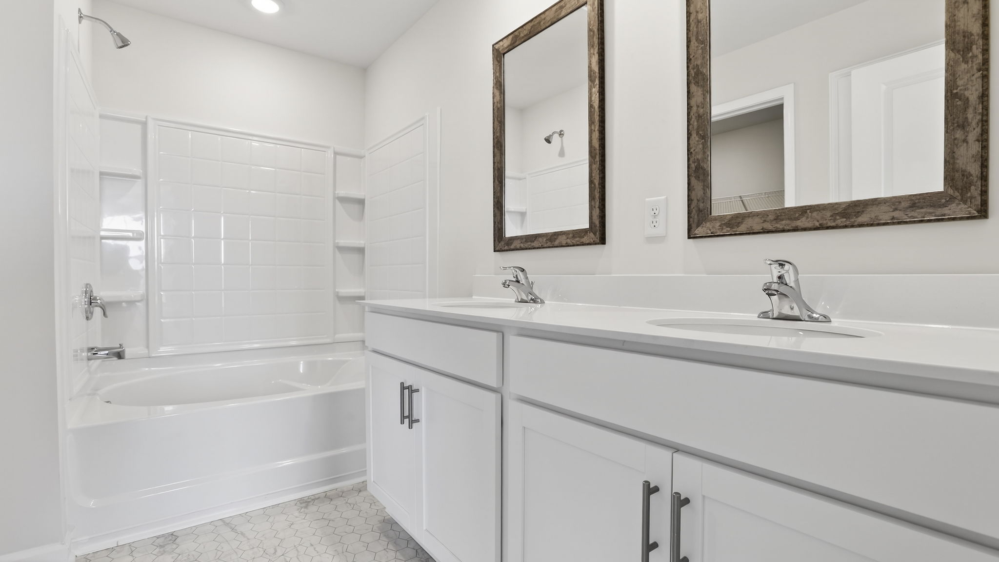 Bathroom with double vanity sink and walk in shower.
