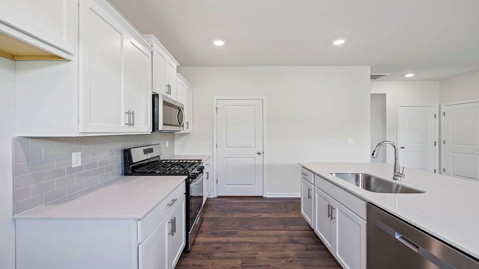 Kitchen and island with granite counter tops.