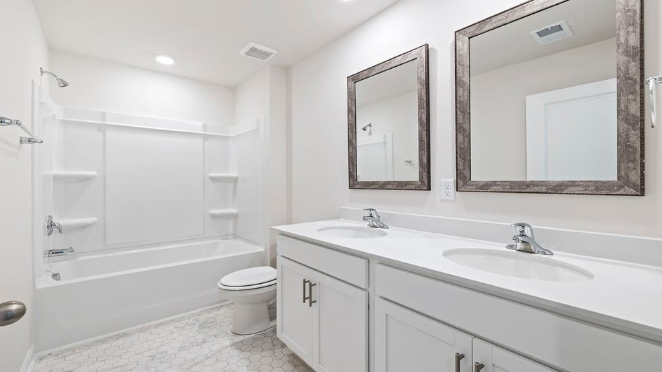 Bathroom with double vanity and tub.