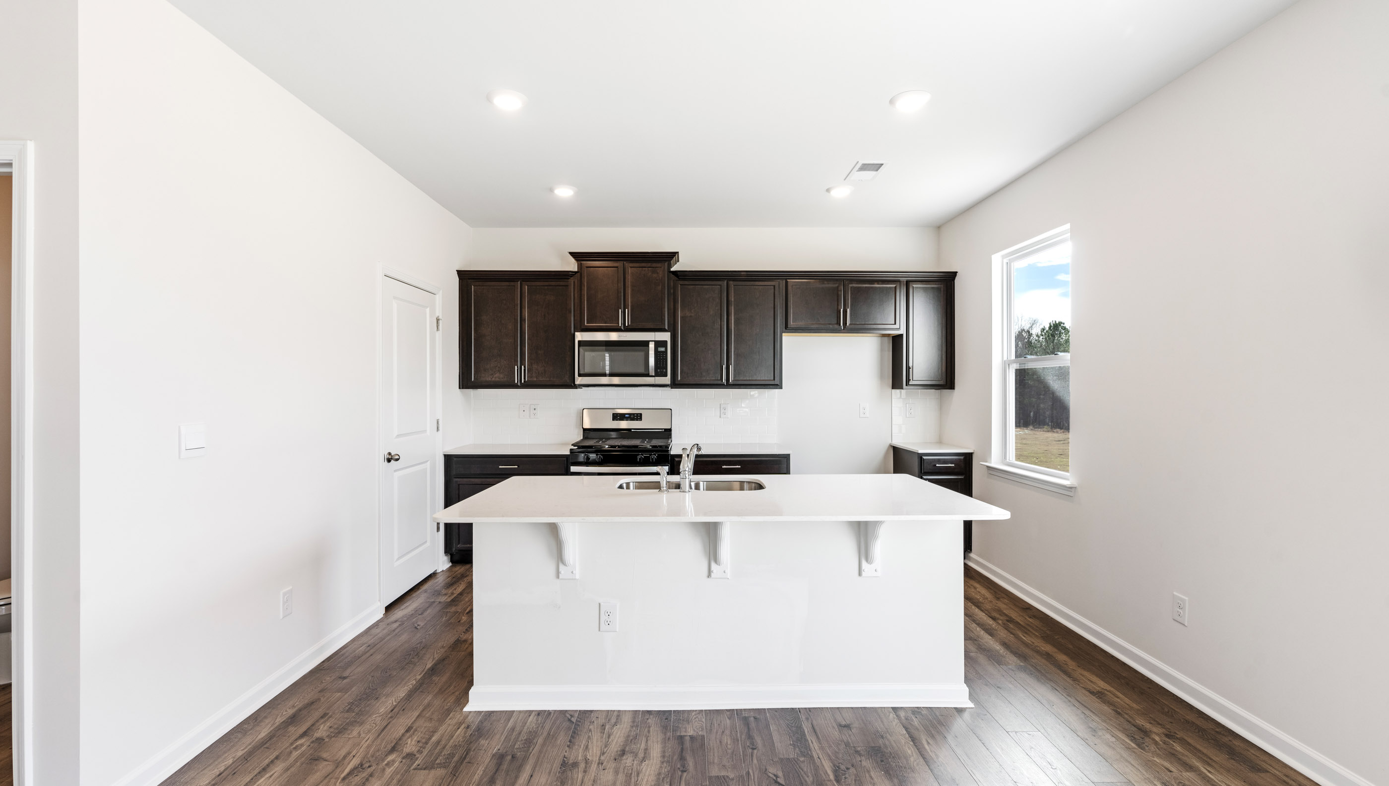 Kitchen with island and granite countertops.