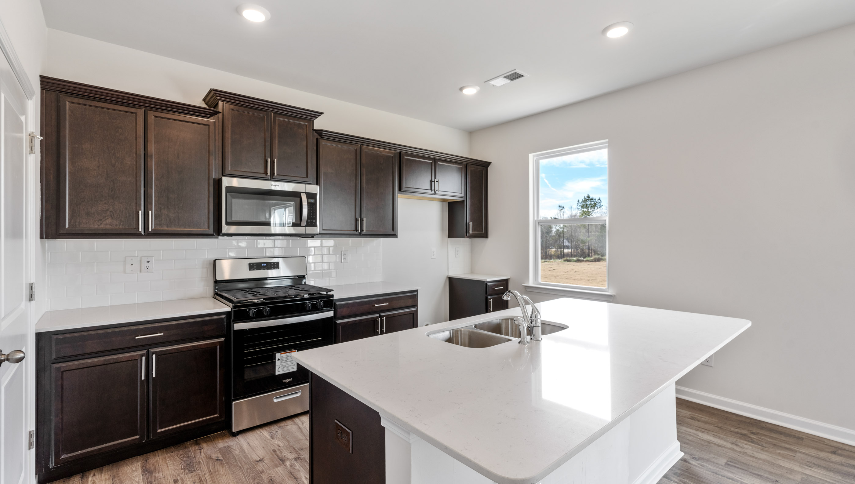 Kitchen with island and granite countertops.