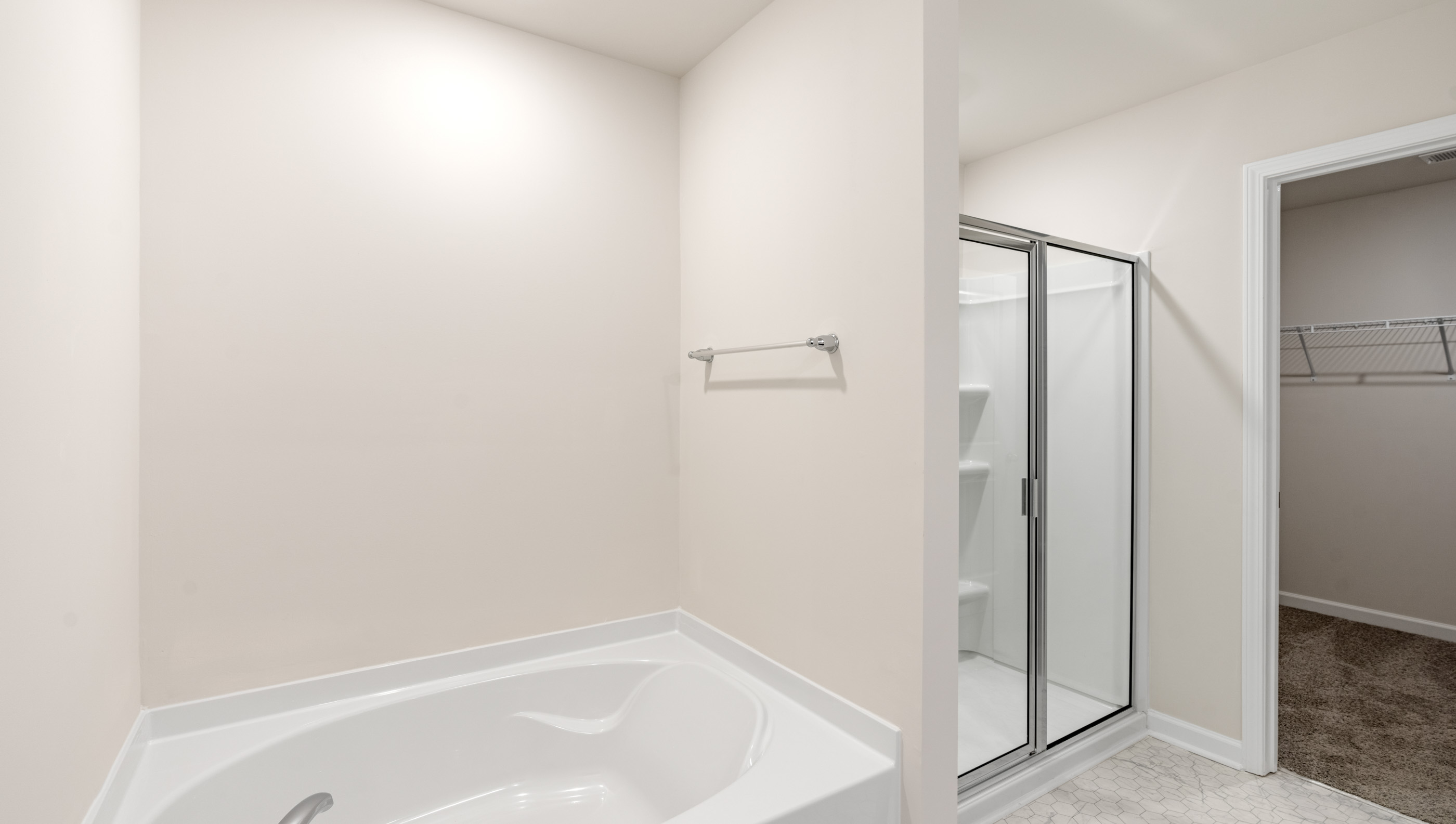 Bathroom with tub and walk in shower.