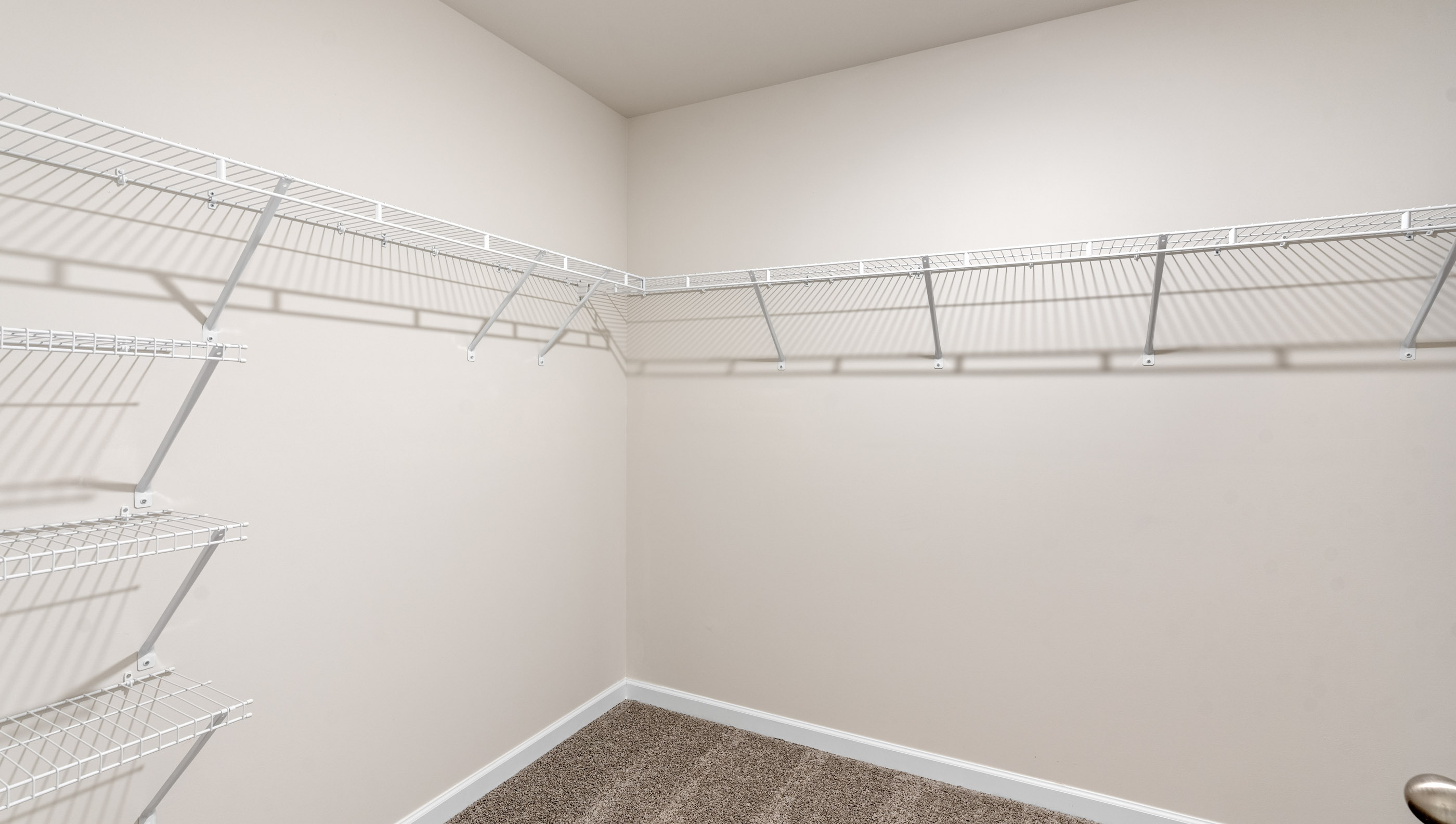 Walk in closet with shelves.