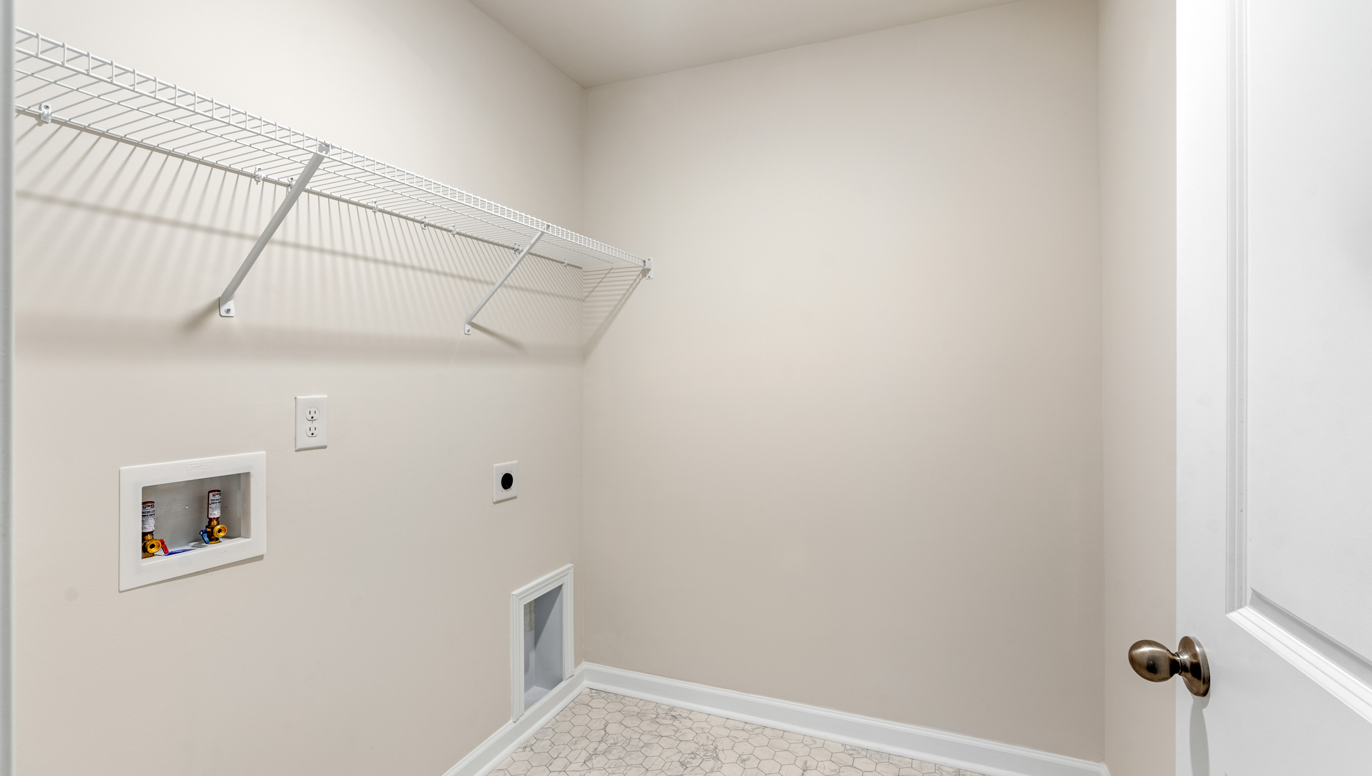 Walk in laundry with shelves.