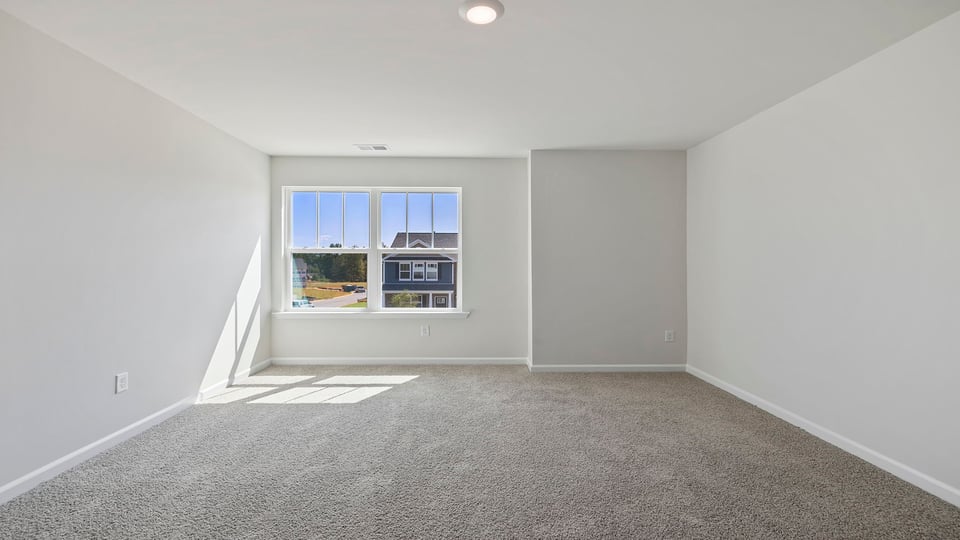 Bedroom with carpet and windows.