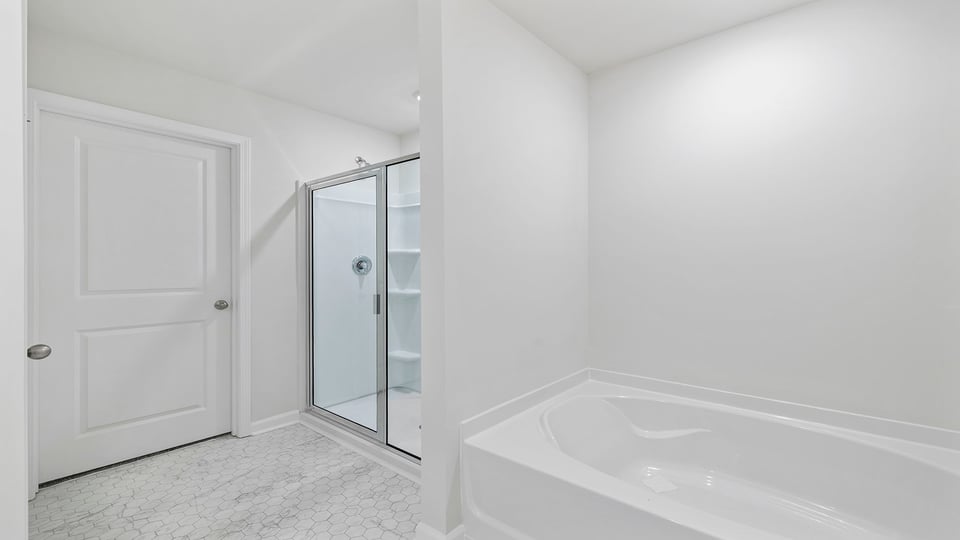 Bathroom with tub and walk in shower.