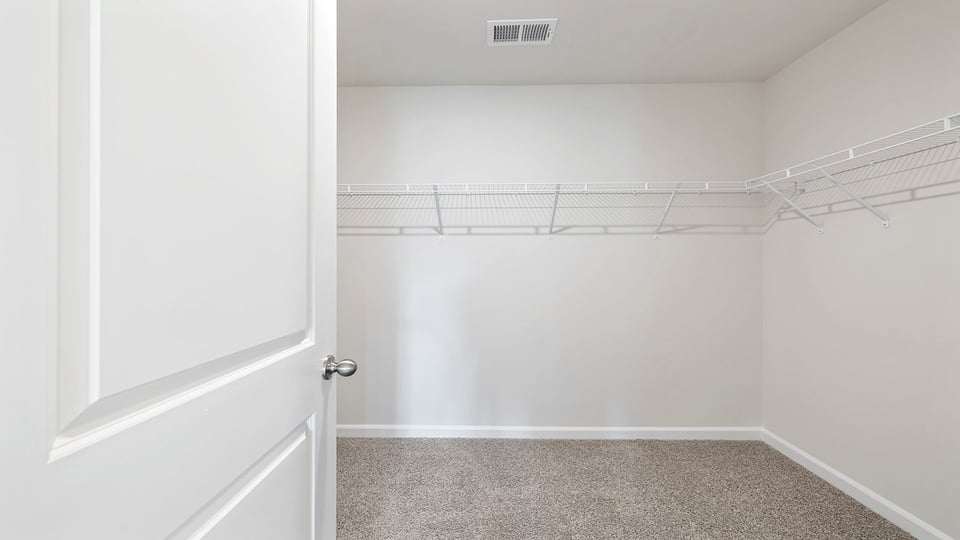 Walk in closet with shelves.