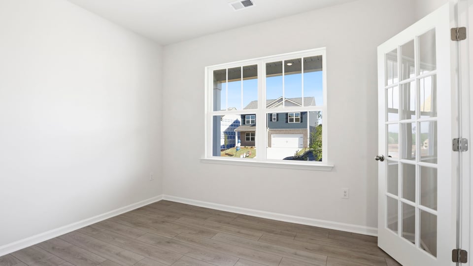 Bedroom with carpet and window.