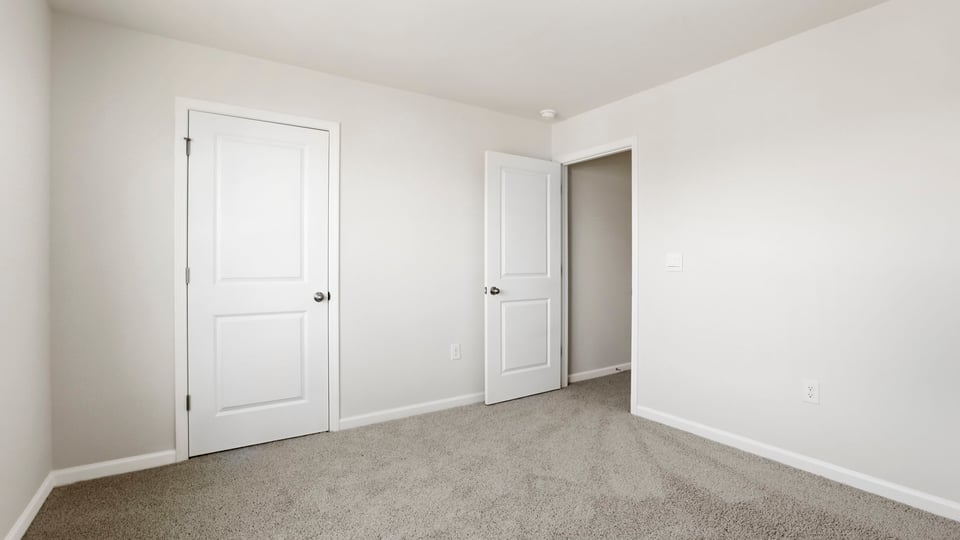 Bedroom with carpet and window.