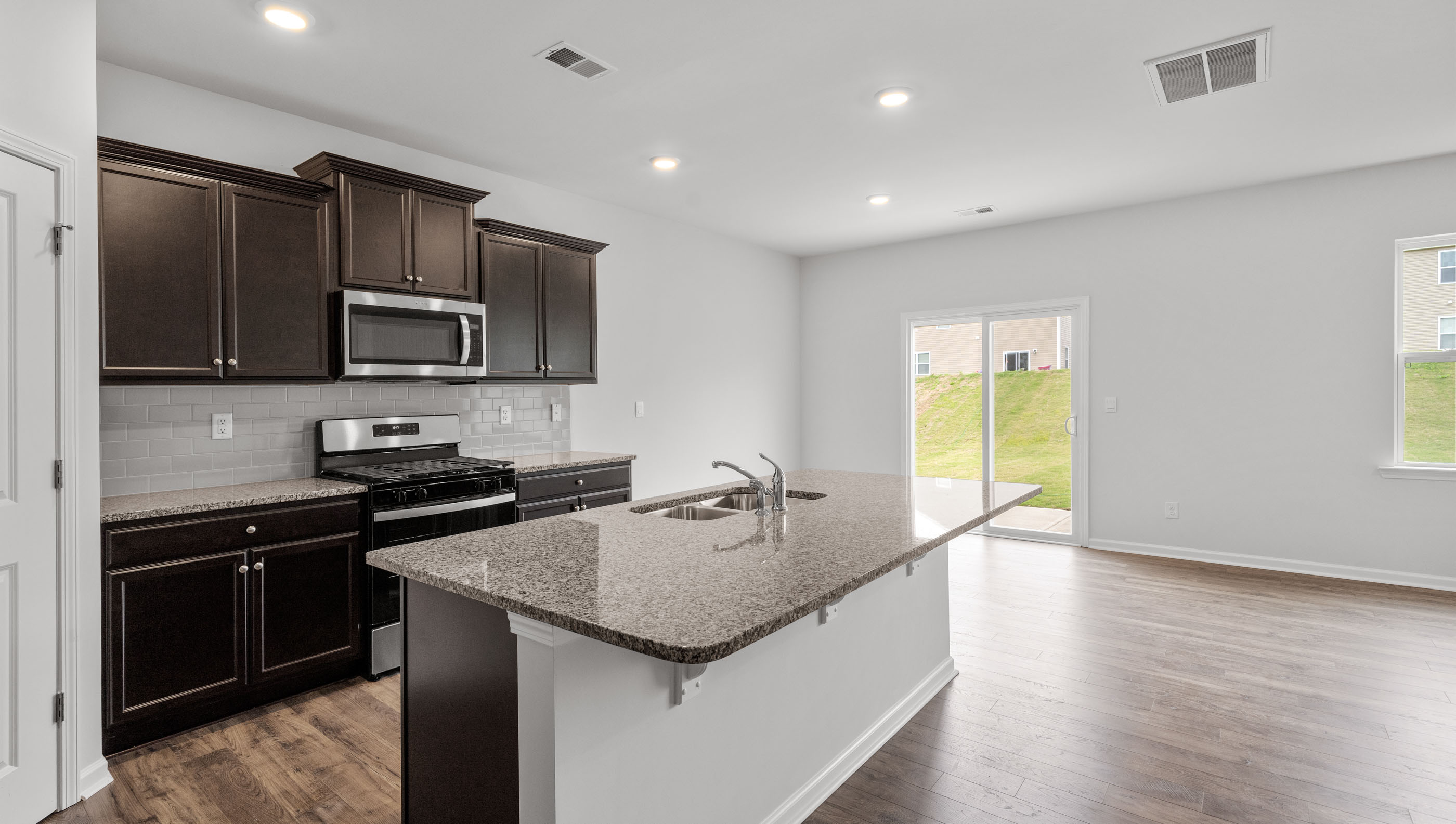 Kitchen with island and granite countertops.