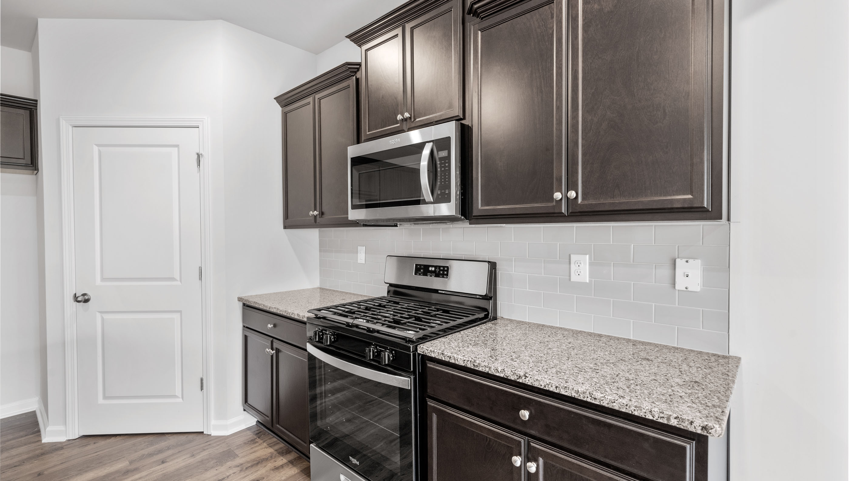 Kitchen with granite countertops and stainless steel appliances.