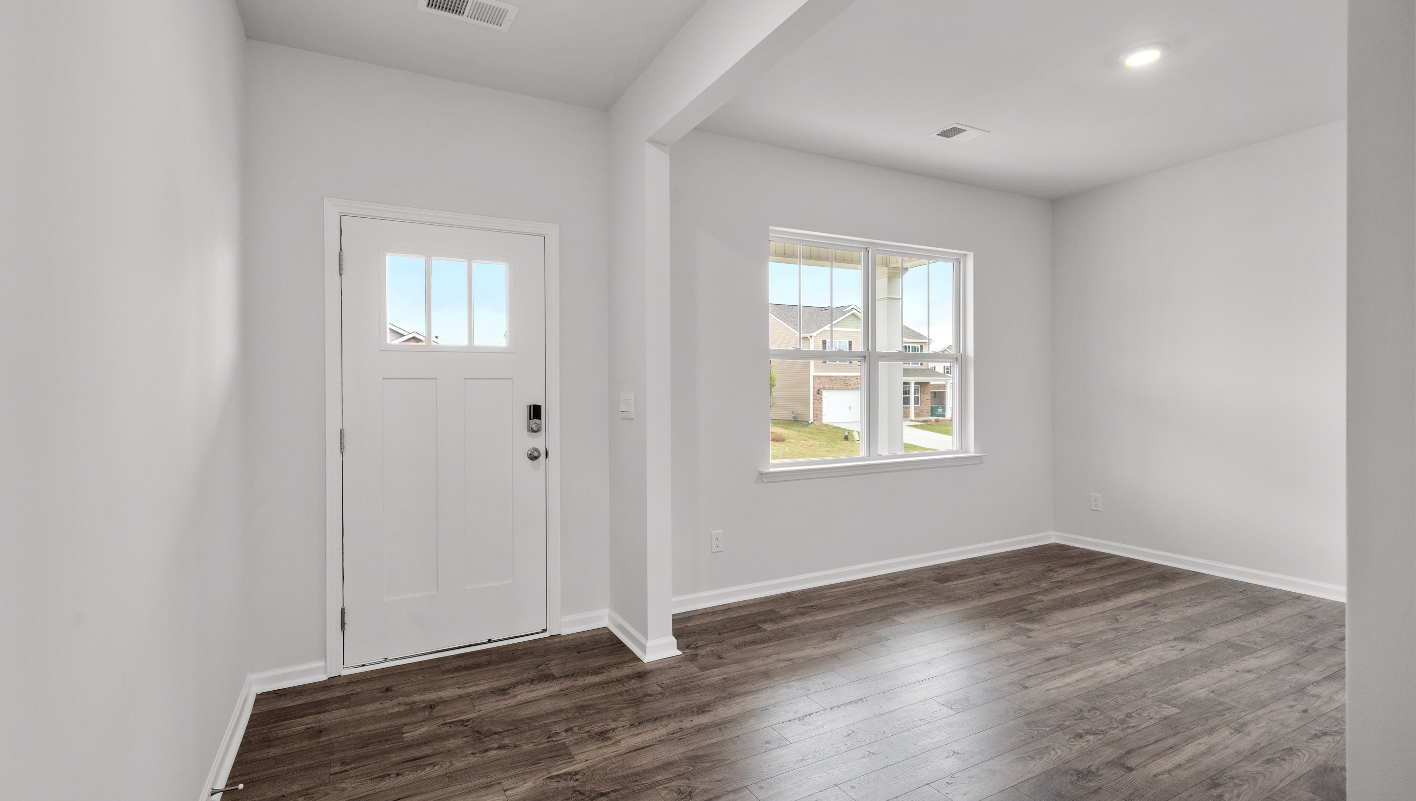 Study with windows and view of front door.