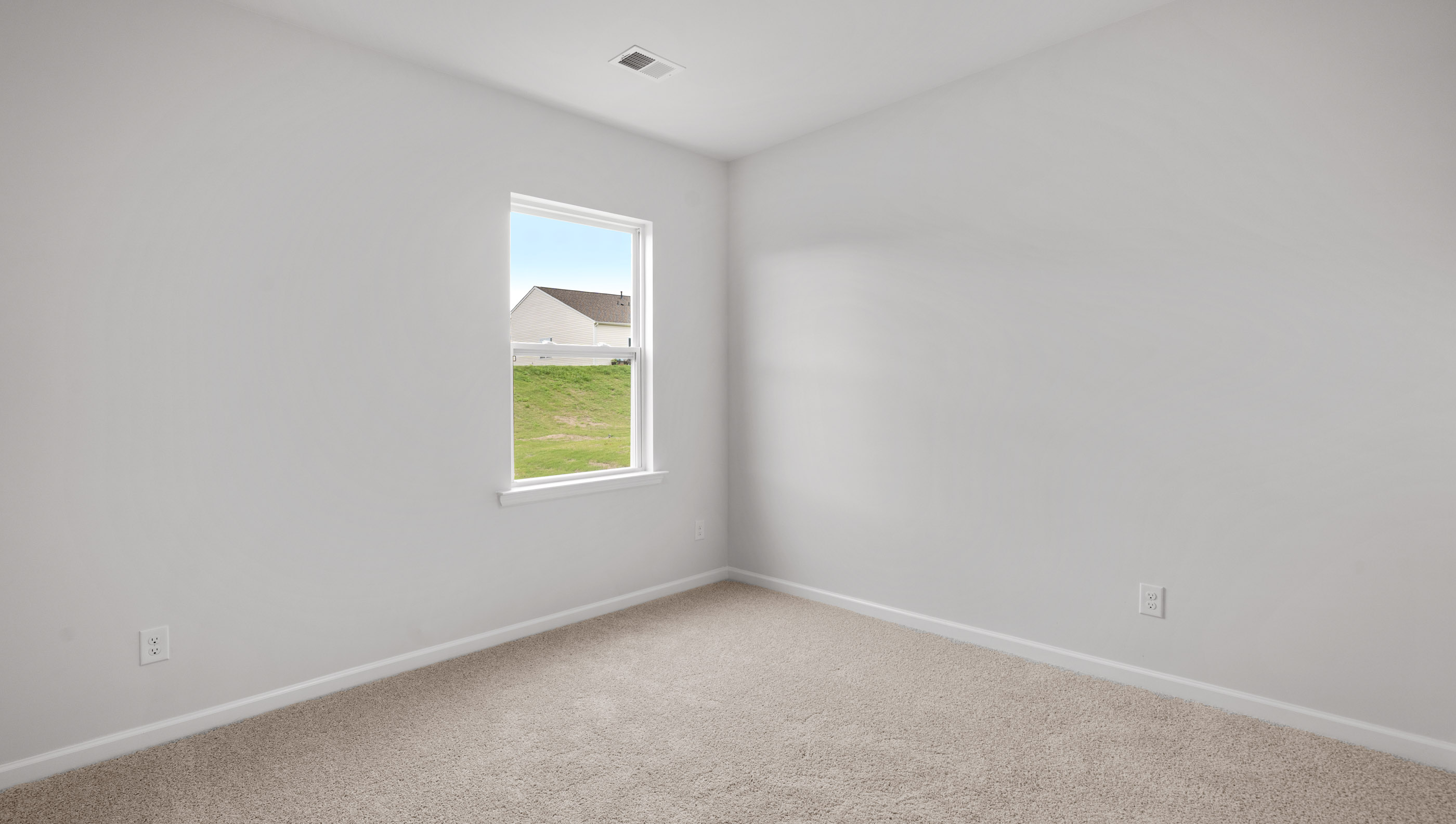 Bedroom with carpet and windows.