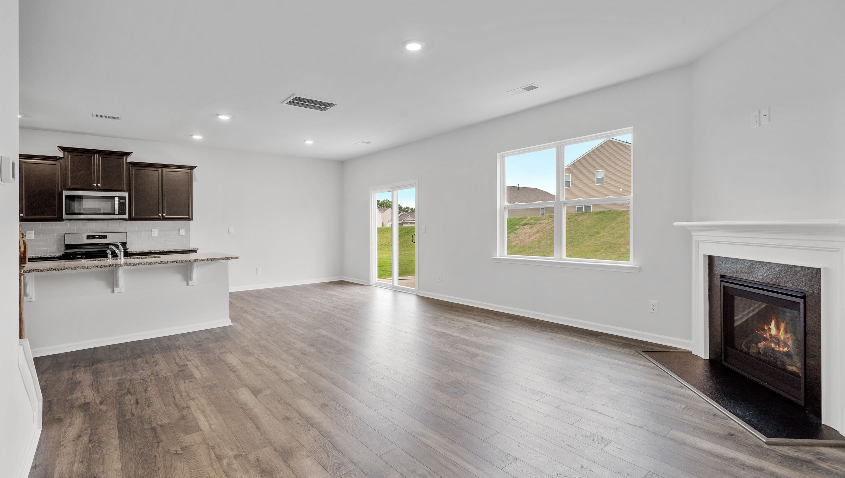 Living room with fireplace facing kitchen.