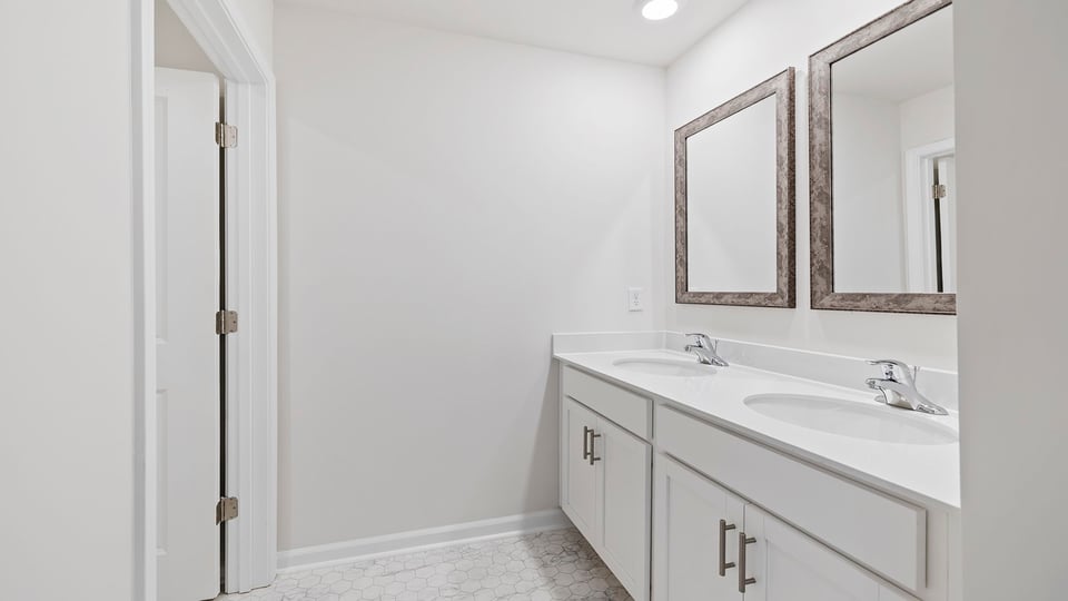 Bathroom with vanity and mirrors.