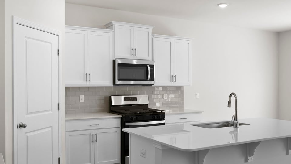 Kitchen with island and countertops.