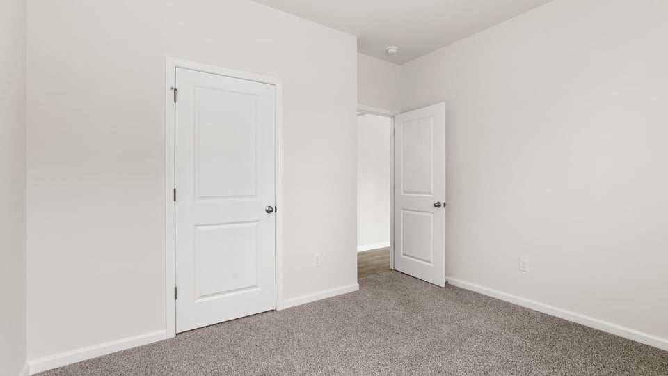 Bedroom with carpet and window.