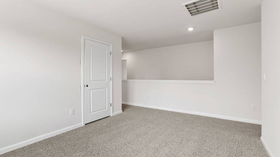 Bedroom with carpet and window.
