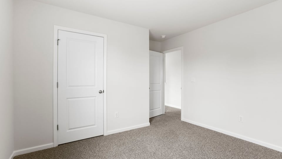 Bedroom with carpet and window.