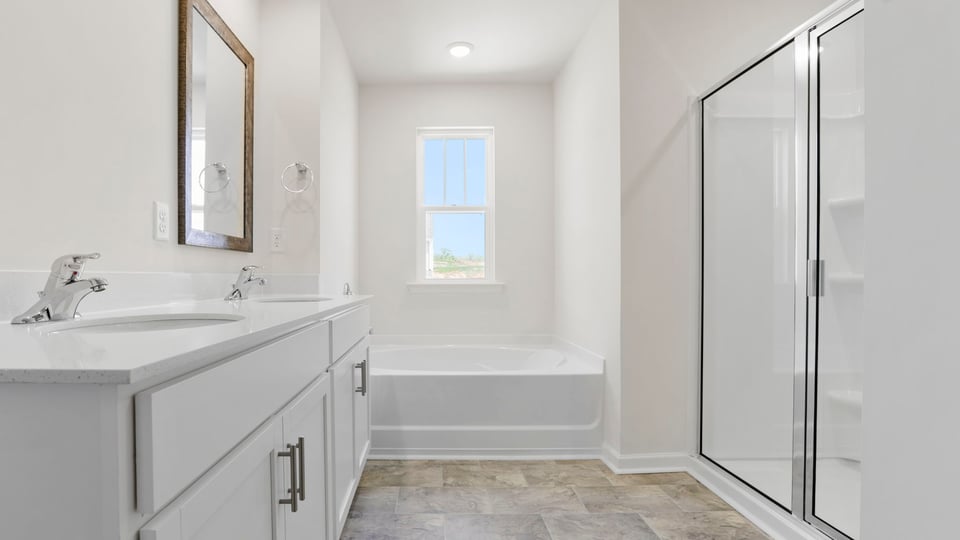 Bathroom with vanity and walk in shower.