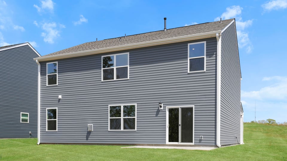 Exterior of home with large backyard.
