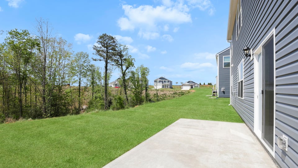 Exterior of home with large backyard.