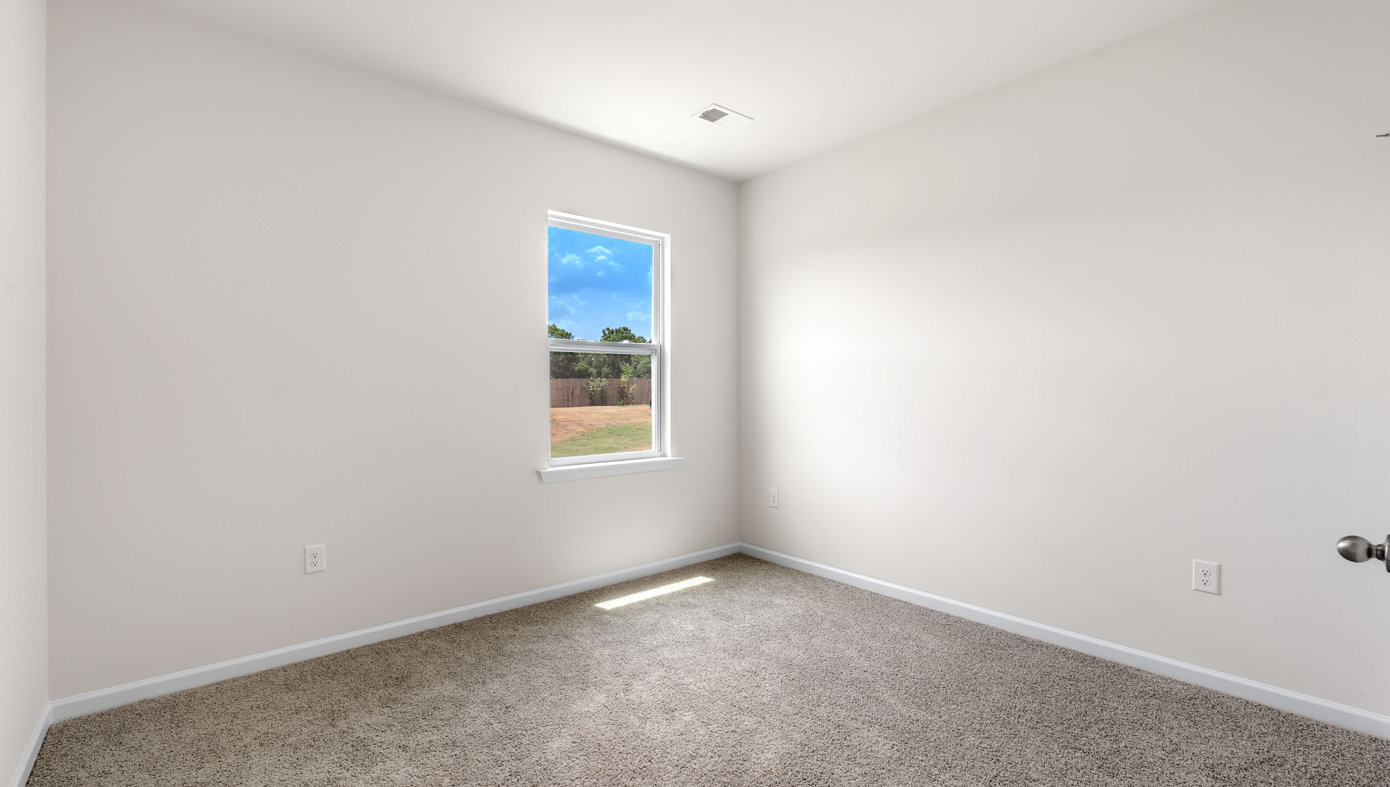 Bedroom with carpet and windows.