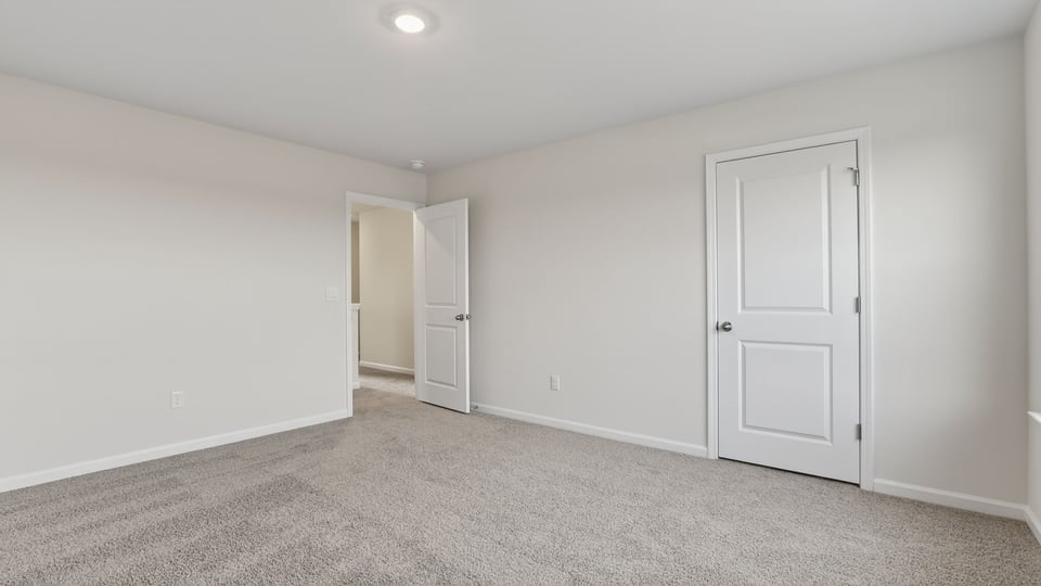 Bedroom with carpet and window.