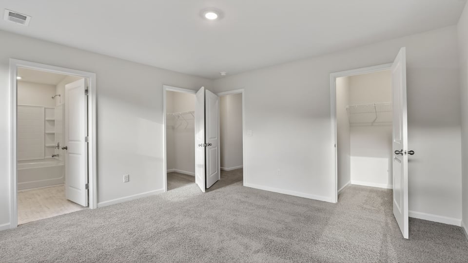 Bedroom with carpet and window.