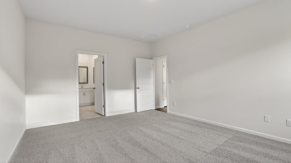 Bedroom with carpet and window.