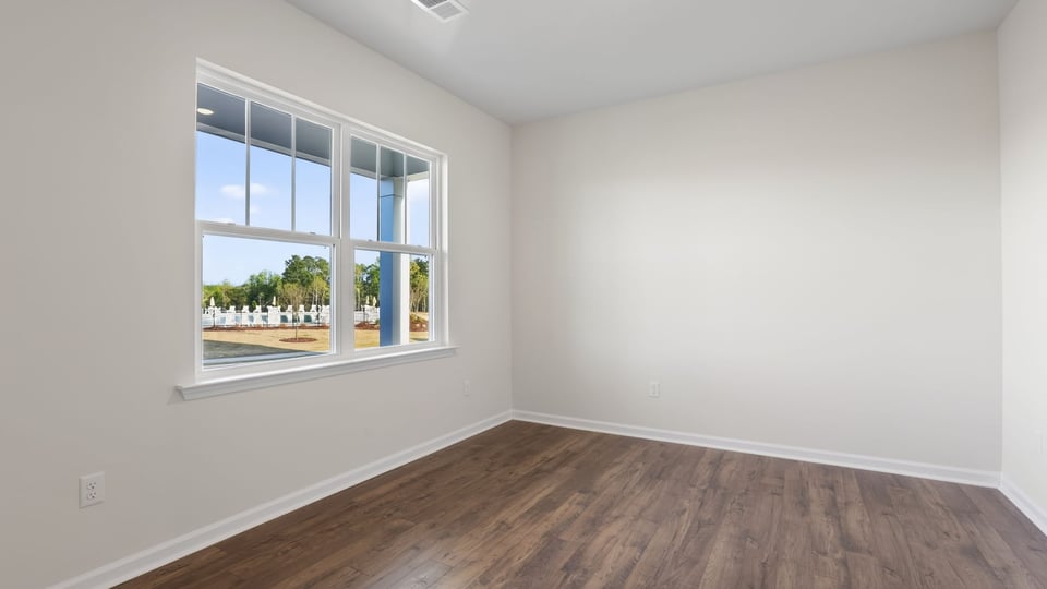 Formal dining room with windows.