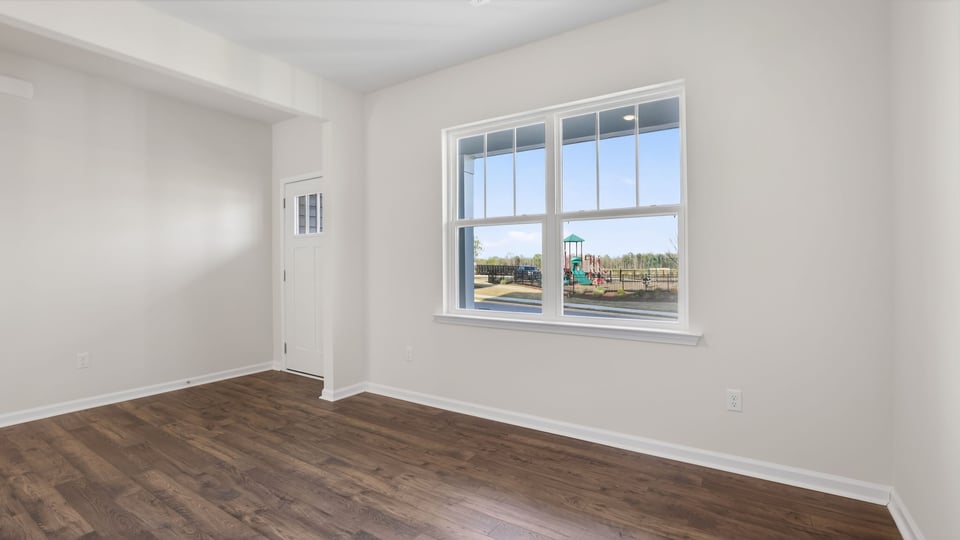Formal dining room with windows.