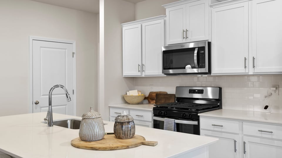 Kitchen and island with quartz countertops.