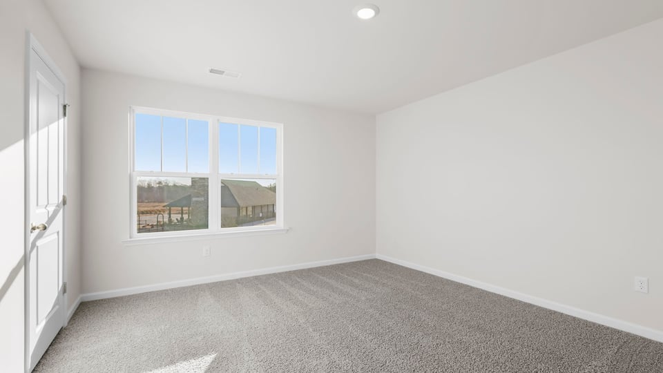 Bedroom with window and carpet.