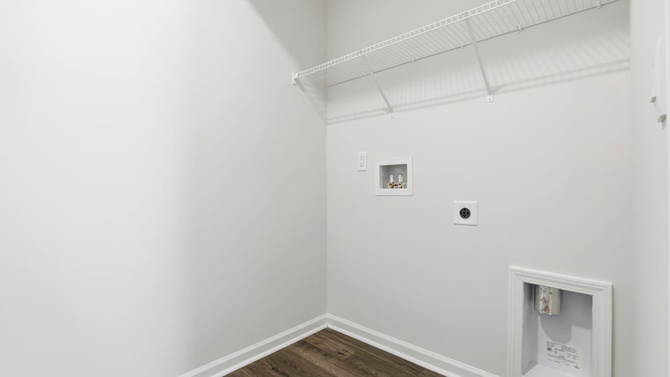 Walk in laundry with shelves.