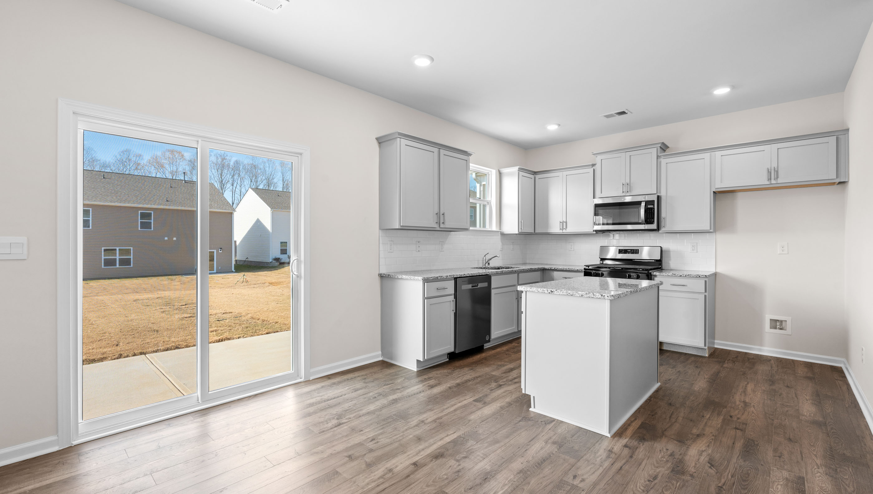 Kitchen and island with granite counter tops.