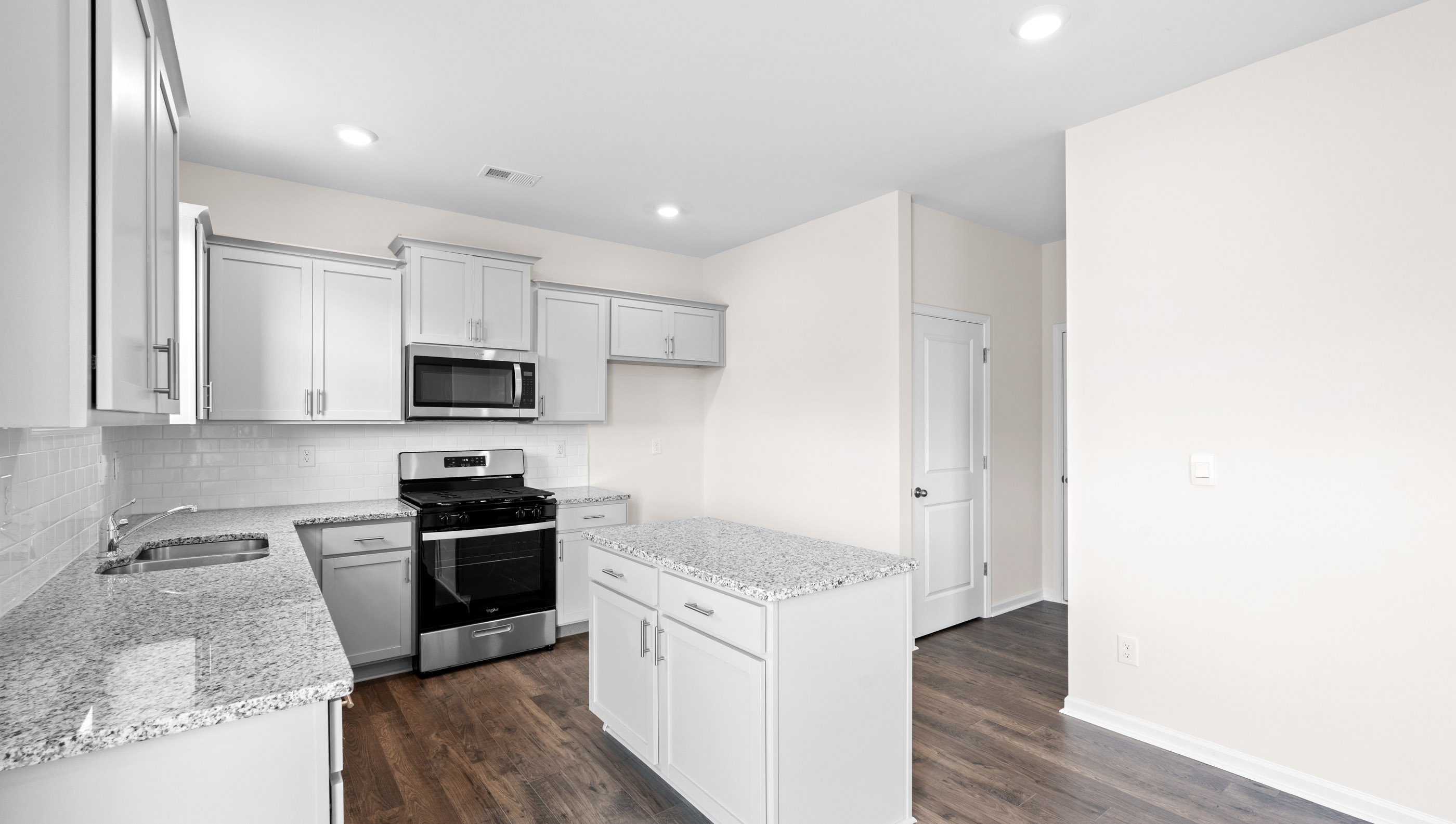 Kitchen and island with granite counter tops.