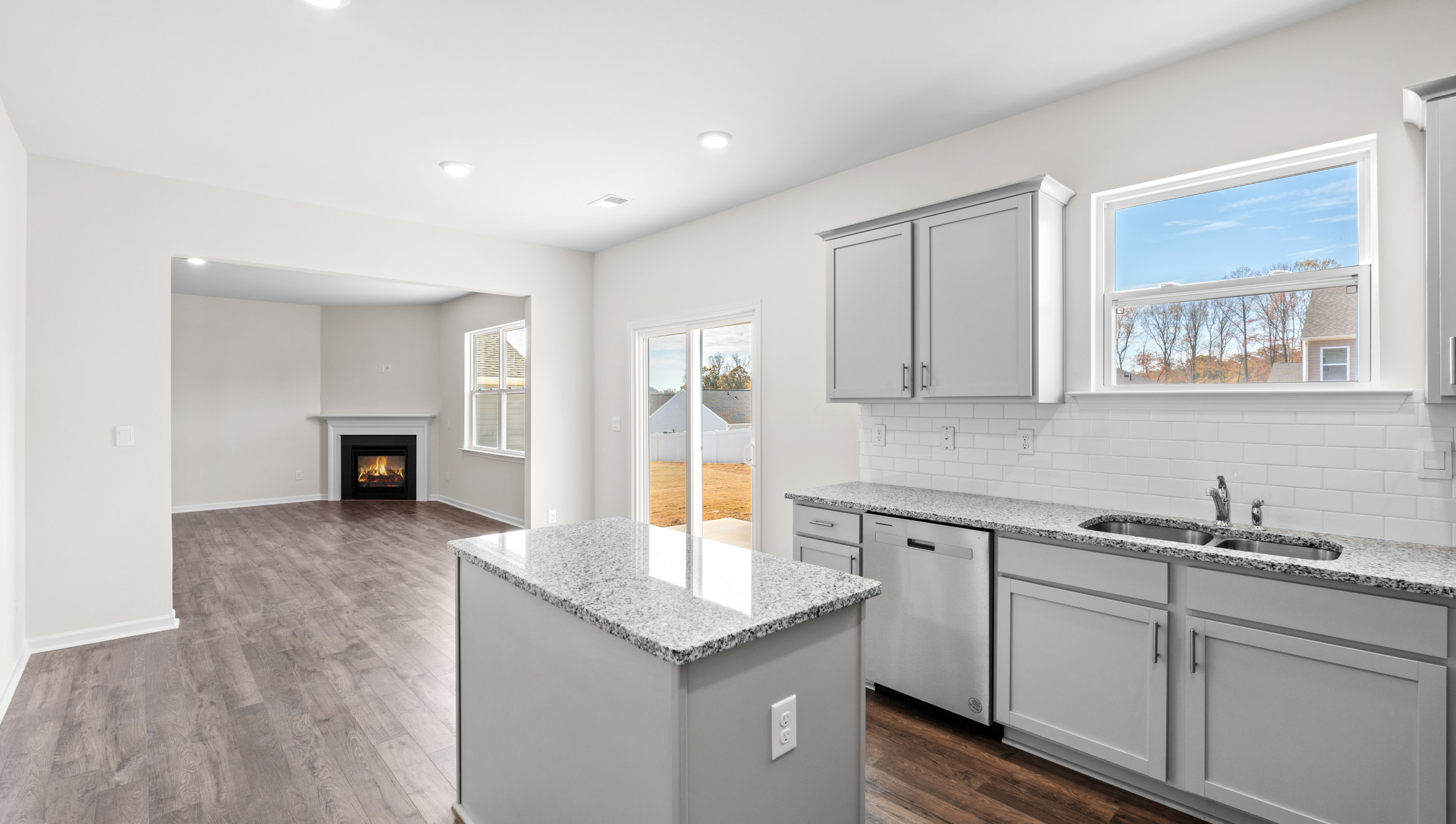Kitchen and island with granite counter tops.