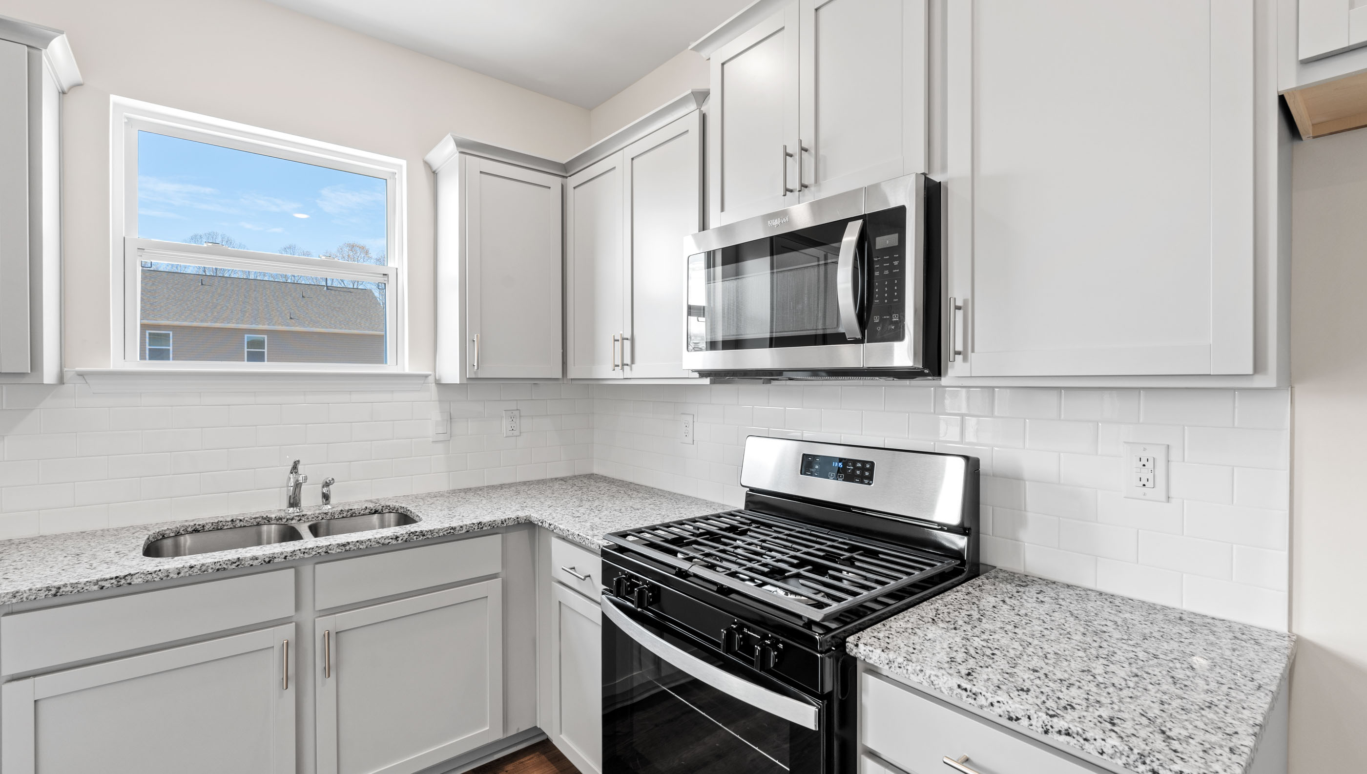 Kitchen and island with granite counter tops.
