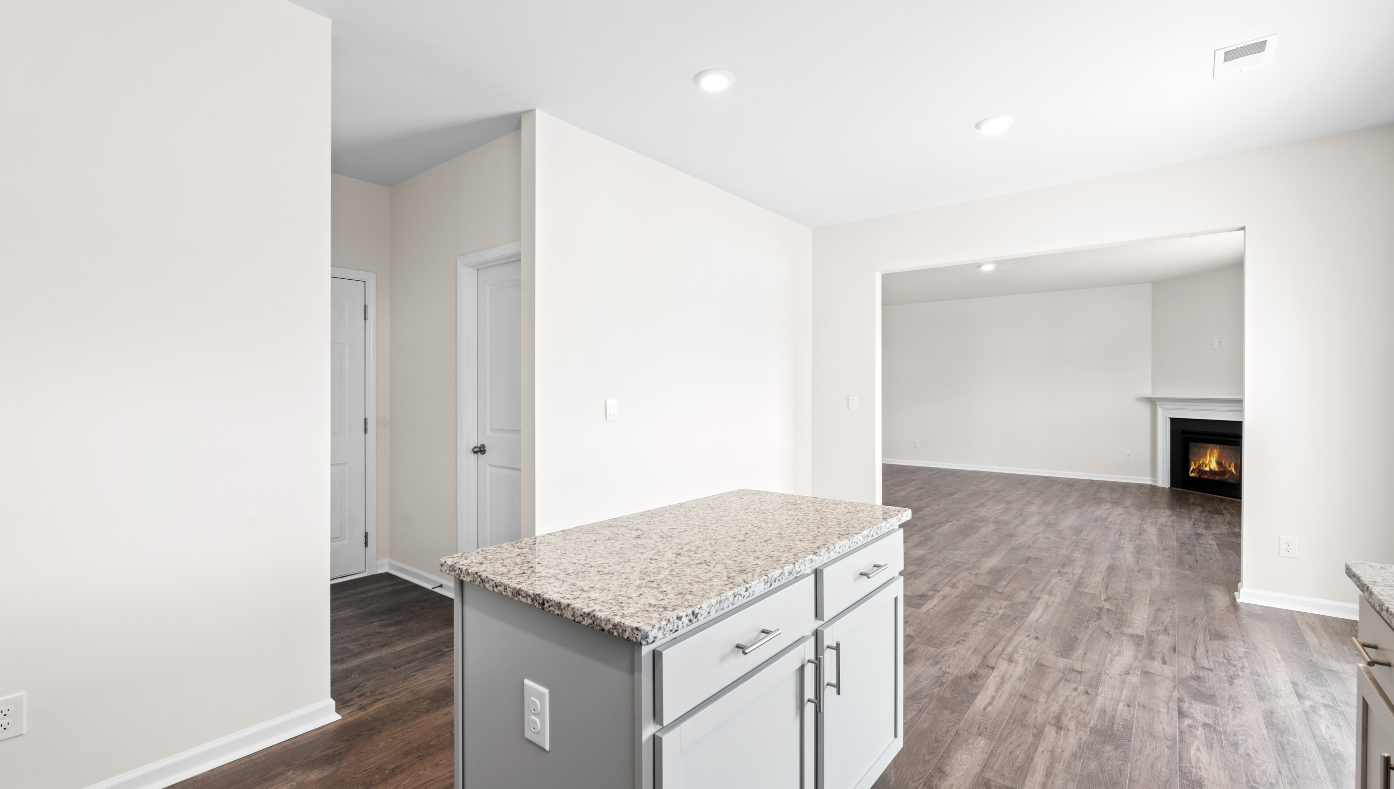 Kitchen and island with granite counter tops.