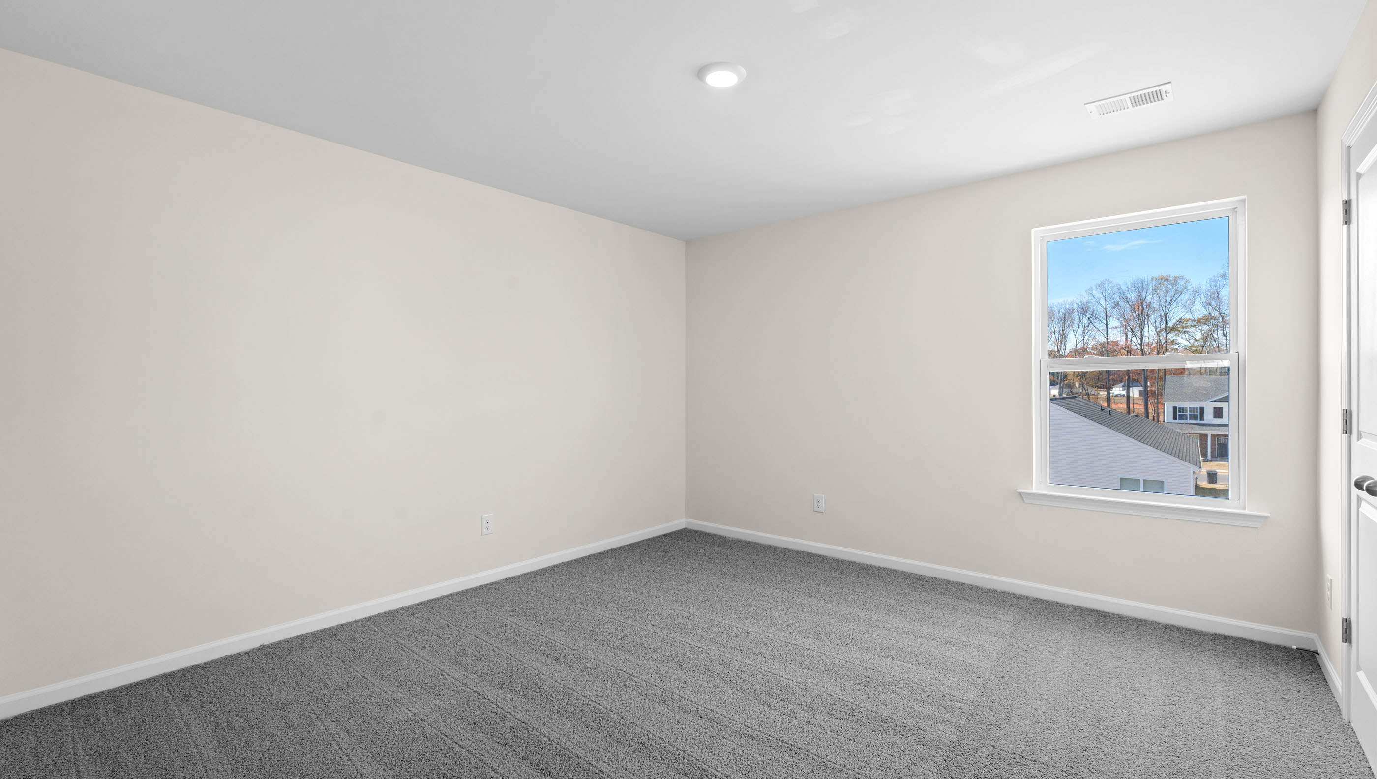Bedroom 1 with window and carpet.