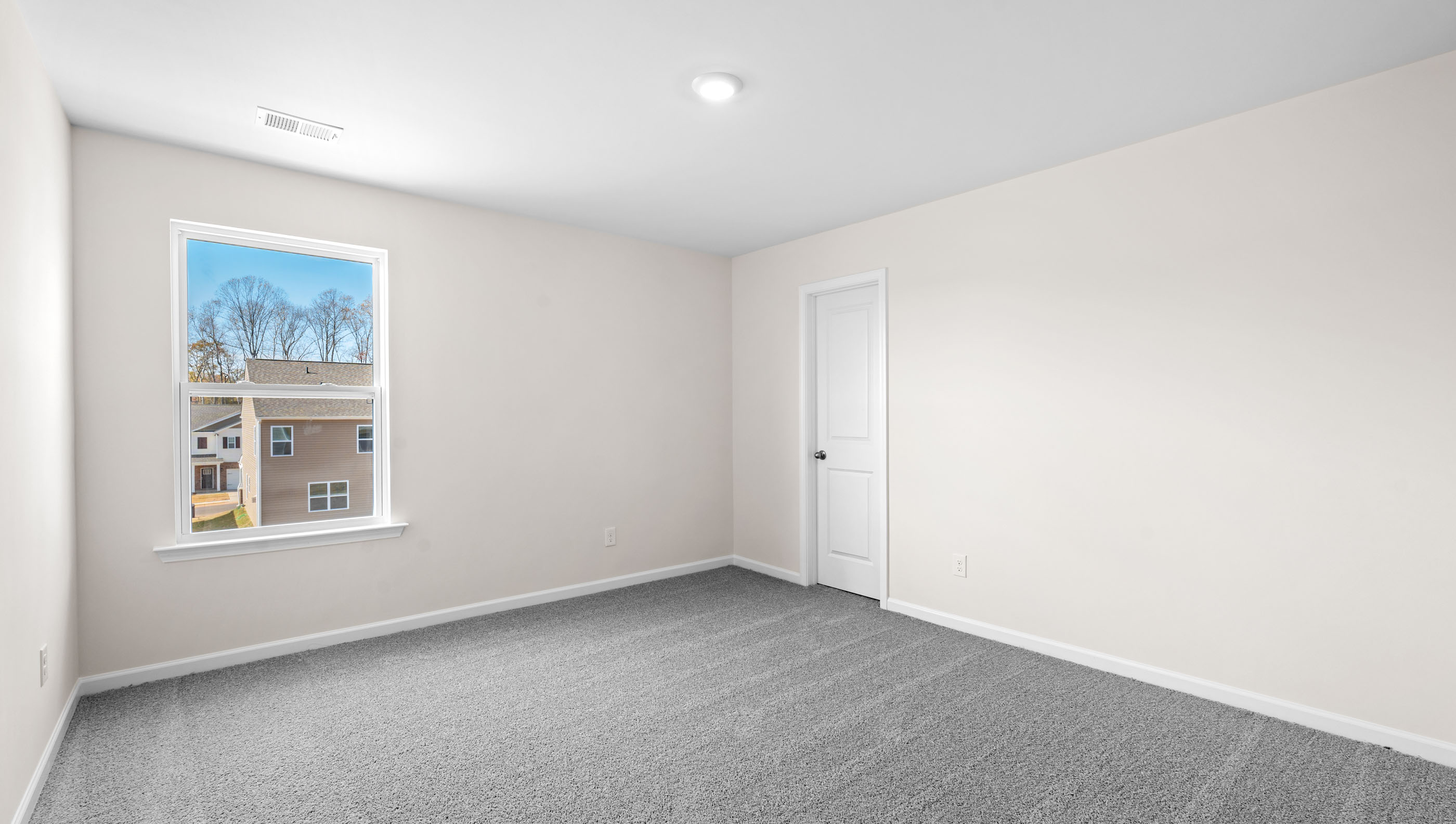 Bendroom 2 with window and carpet.