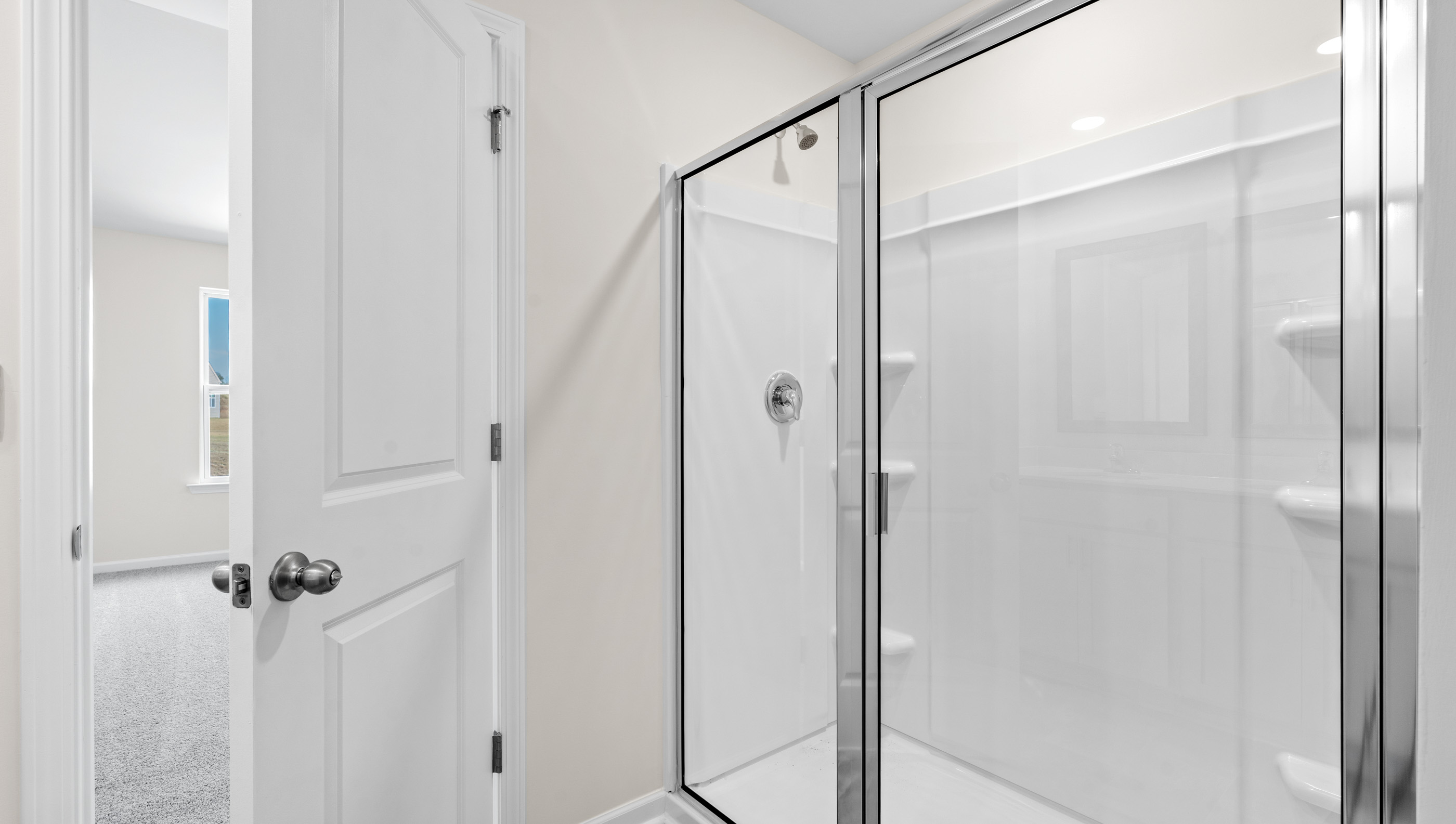 Primary bedroom with walk in shower.