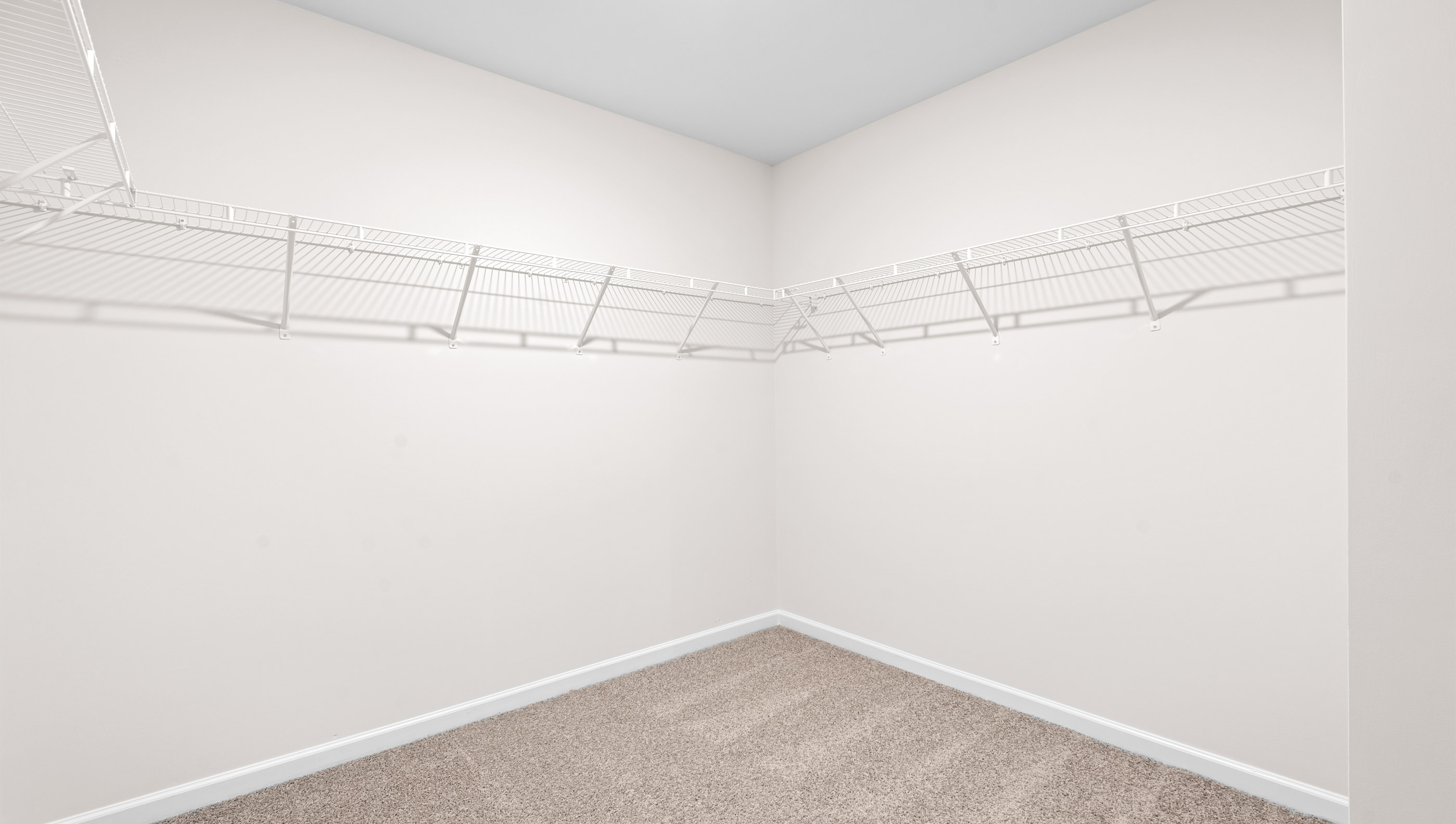 Walk in closet of primary bedroom.