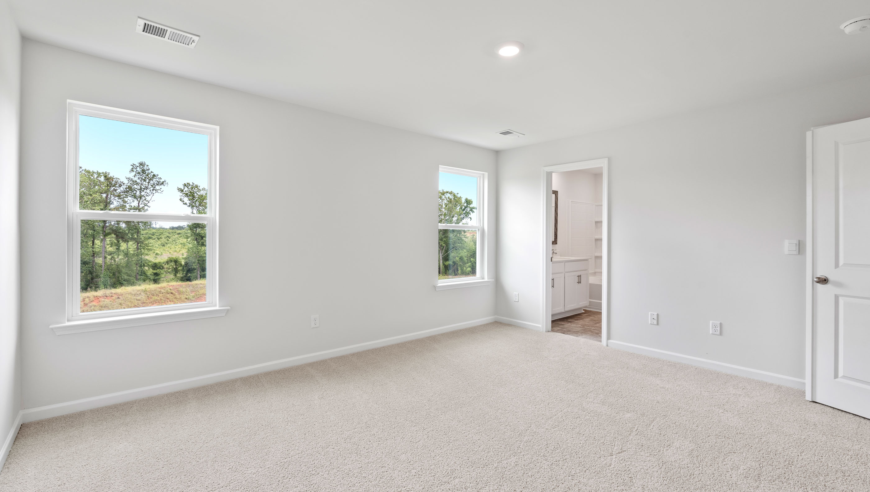 Bedroom with carpet and window.
