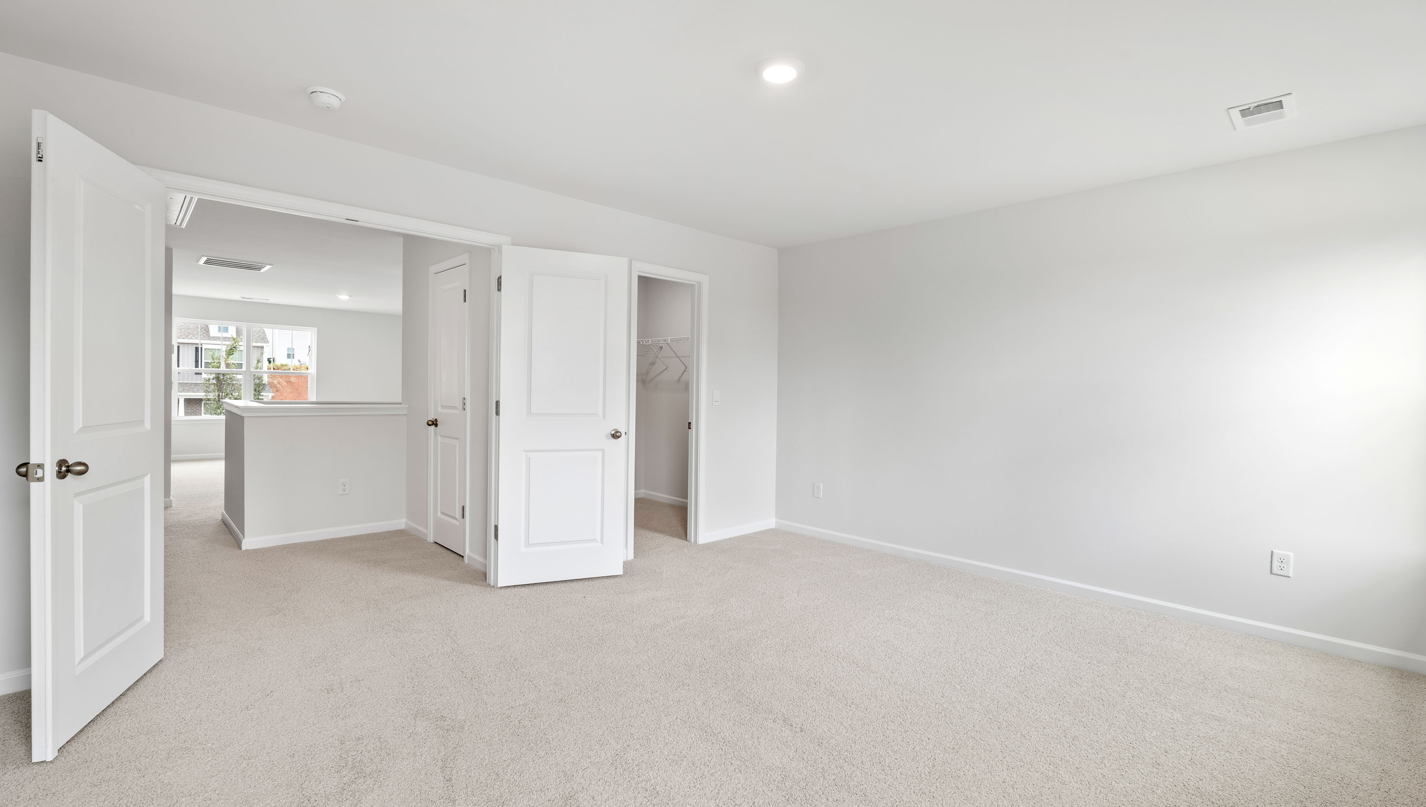 Bedroom with carpet and window.