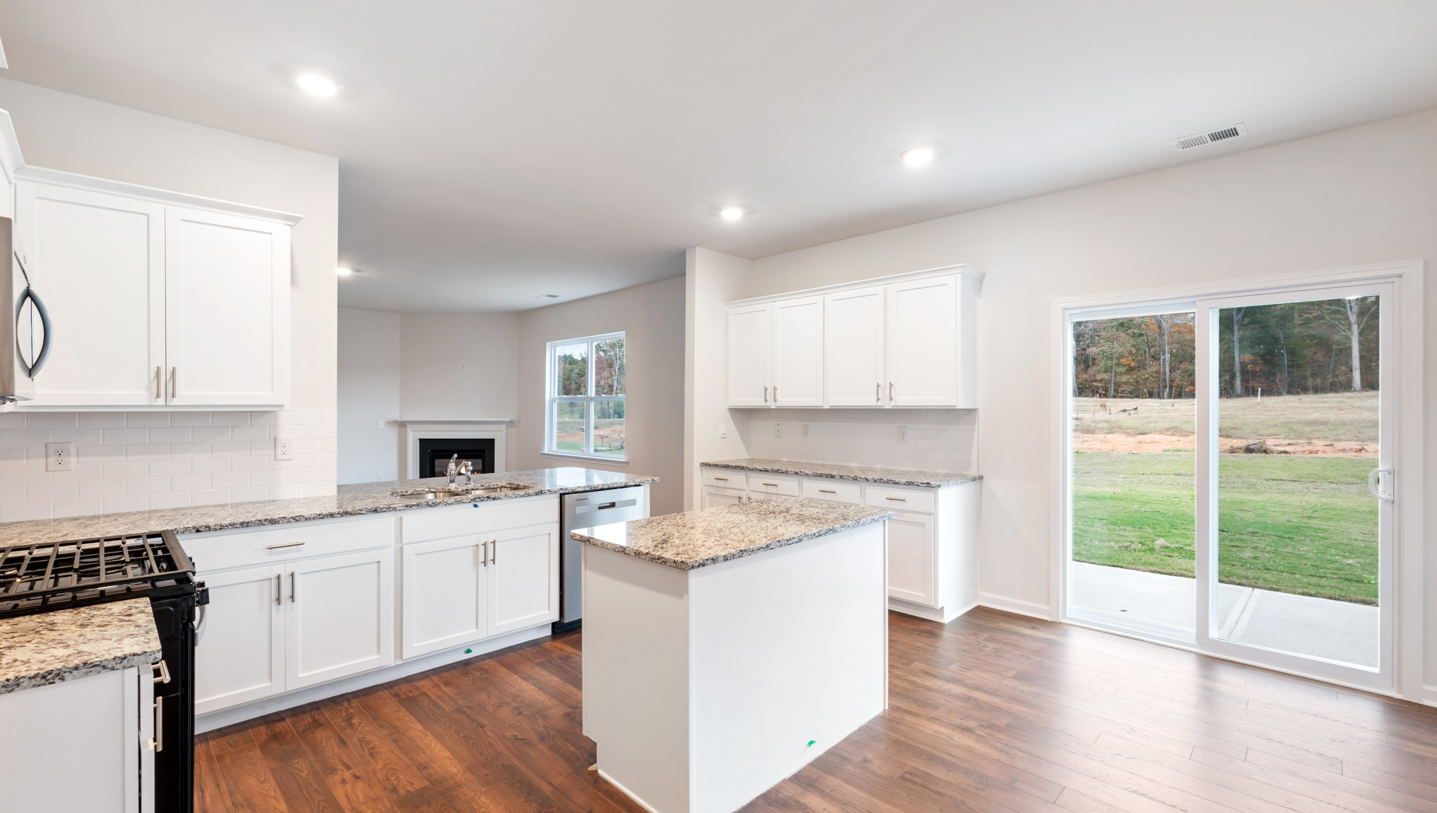 Kitchen with island and granite countertops.