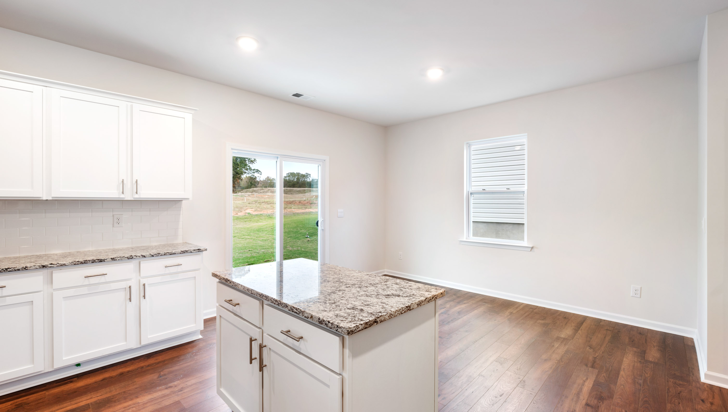 Kitchen with island and granite countertops.