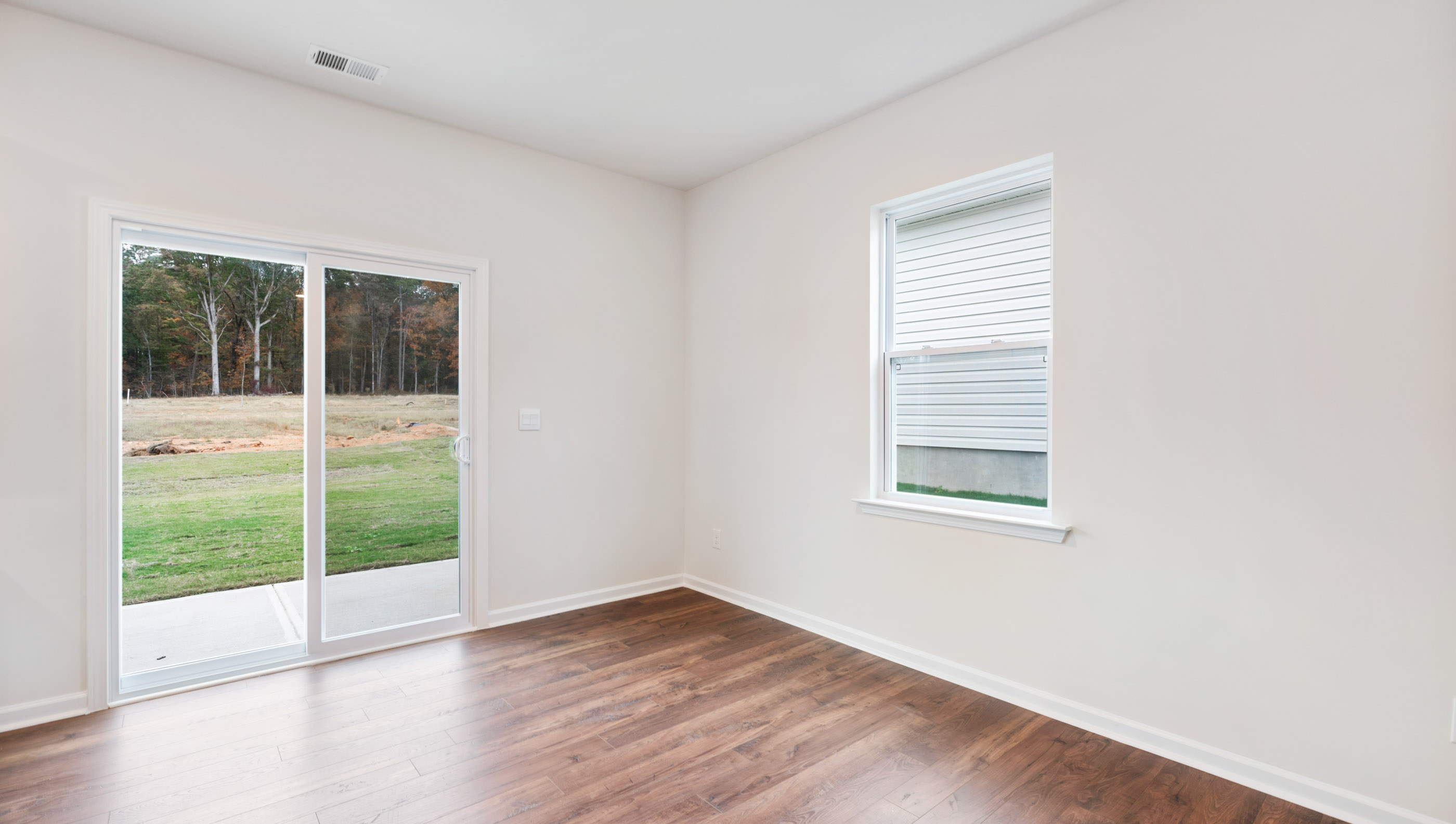 Breakfast area with windows and door to backyard.